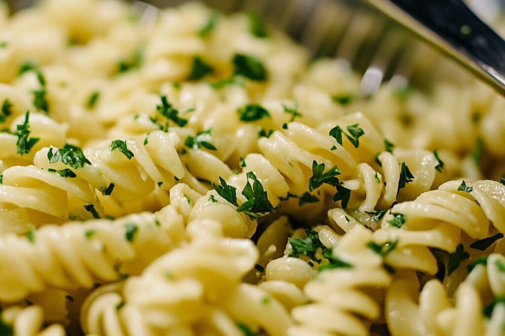 Pasta salad with creamy dressing evenly coating the pasta, showcasing the benefits of proper rinsing