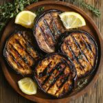 grilled eggplant slices with char marks and herbs