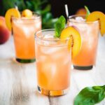 peach lemonade in mason jar with fruit slices