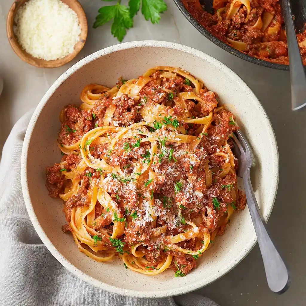 Delicious plate of Bolognese Pasta with rich sauce and fresh herbs.