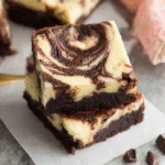 Delicious Chocolate Cheesecake Brownies topped with creamy cheesecake swirls.