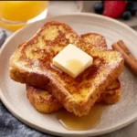 Deliciously prepared French Toast topped with syrup and berries
