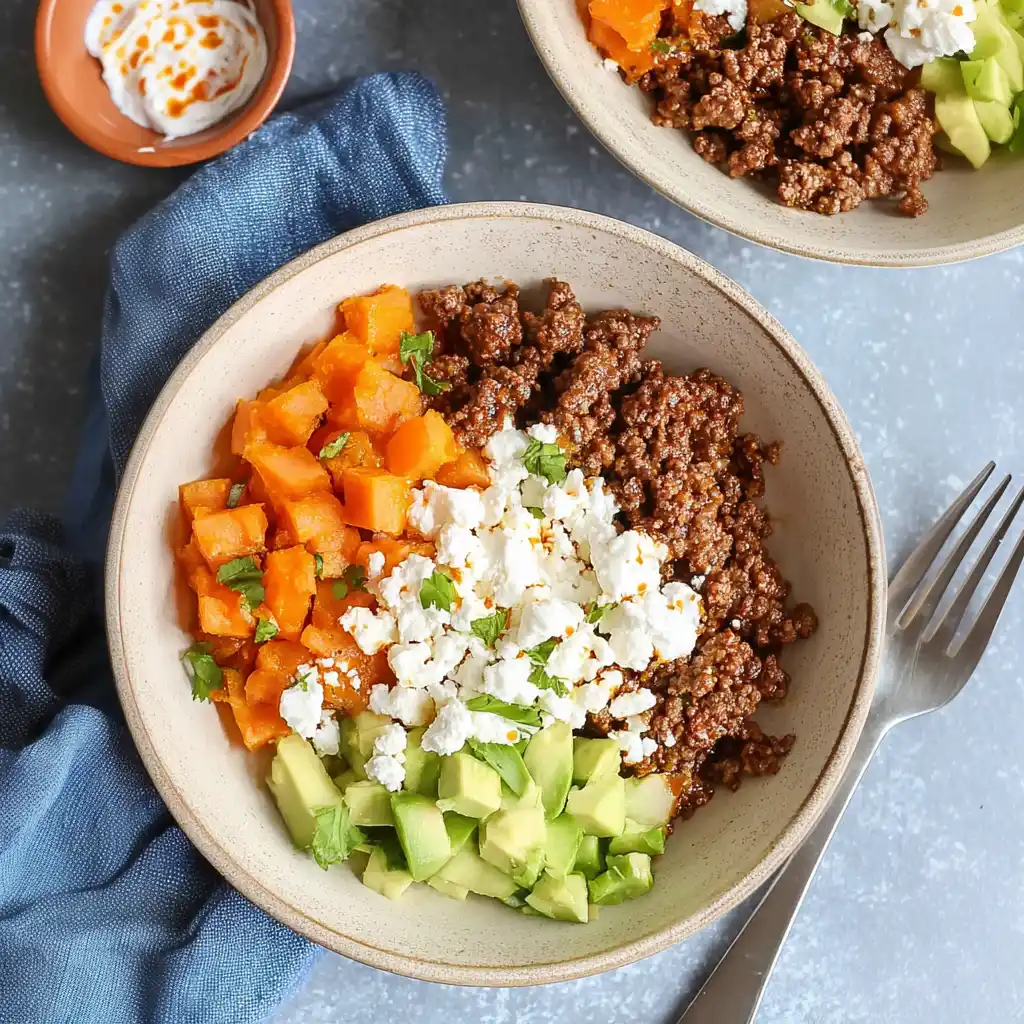 Ground Beef Cottage Cheese Bowl topped with vegetables and seasonings