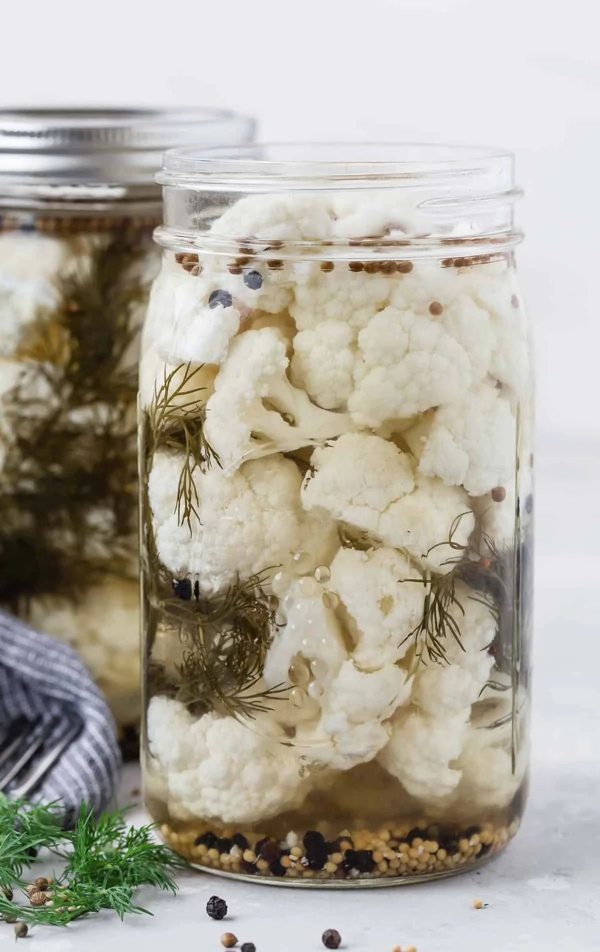 Homemade pickled cauliflower in a jar with spices and vegetables