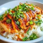 Delicious chicken over rice served with fresh herbs and spices
