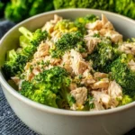 Creamy tuna broccoli casserole served in a baking dish with cheese on top