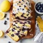 Sliced lemon blueberry bread showcasing vibrant blueberries and lemon zest