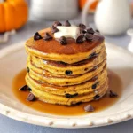 Delicious pumpkin chocolate chip pancakes stacked on a plate