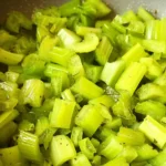 Delicious sautéed celery in a skillet with garlic and herbs