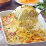 Delicious White Chicken Enchilada Casserole topped with cheese and cilantro