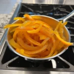 Delicious homemade candied orange peels on a white plate