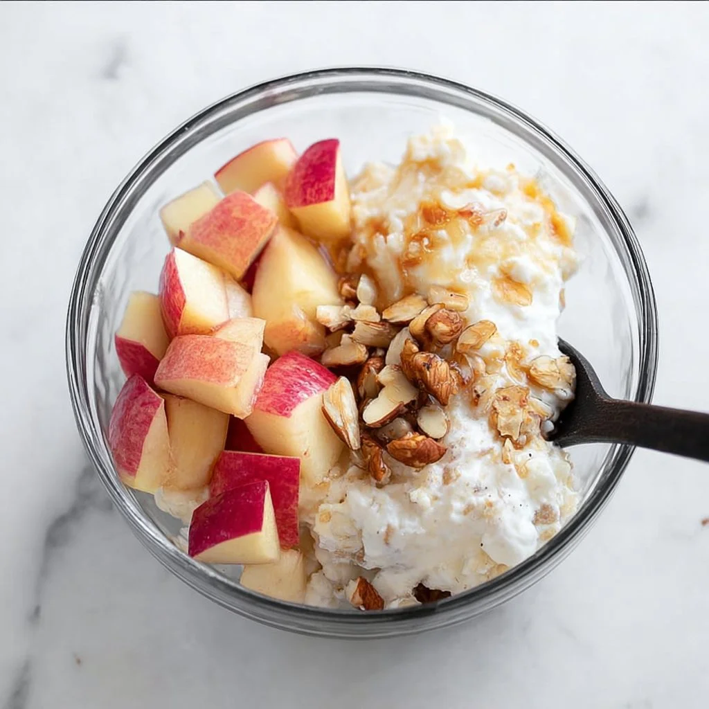 Bowl of cottage cheese topped with fruits and nuts for breakfast