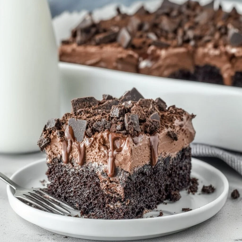 Death by Chocolate Poke Cake topped with chocolate ganache and whipped cream.