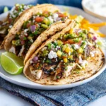 Grilled chimichurri chicken tacos topped with fresh ingredients and vibrant sauces