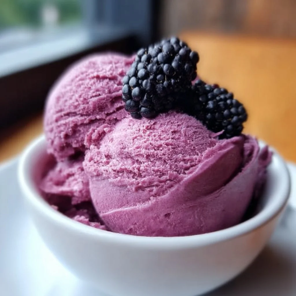 Delicious homemade blackberry ice cream served in a bowl with fresh berries