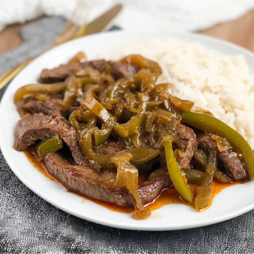 Italian pepper steak served with colorful vegetables on a plate