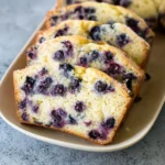Delicious Lemon Blueberry Bread fresh out of the oven with blueberries and lemon zest