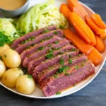 Slow Cooker Corned Beef and Cabbage served on a plate with vegetables