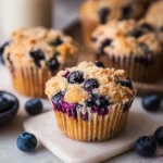 Freshly baked vegan blueberry muffins on a cooling rack
