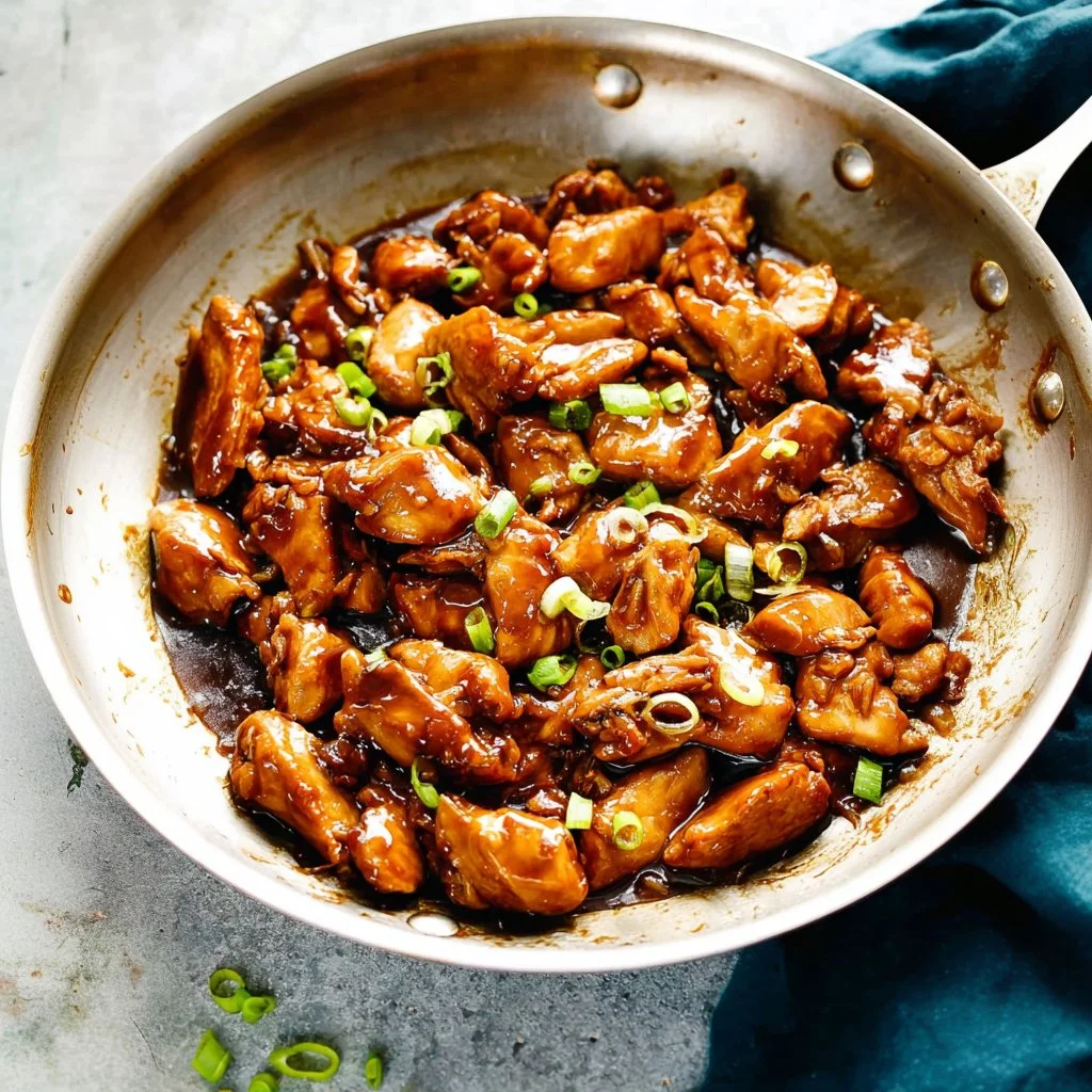 Delicious Bourbon Chicken served with colorful vegetables on a plate.