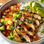 Delicious Chicken and Rice Bowl topped with fresh herbs and spices