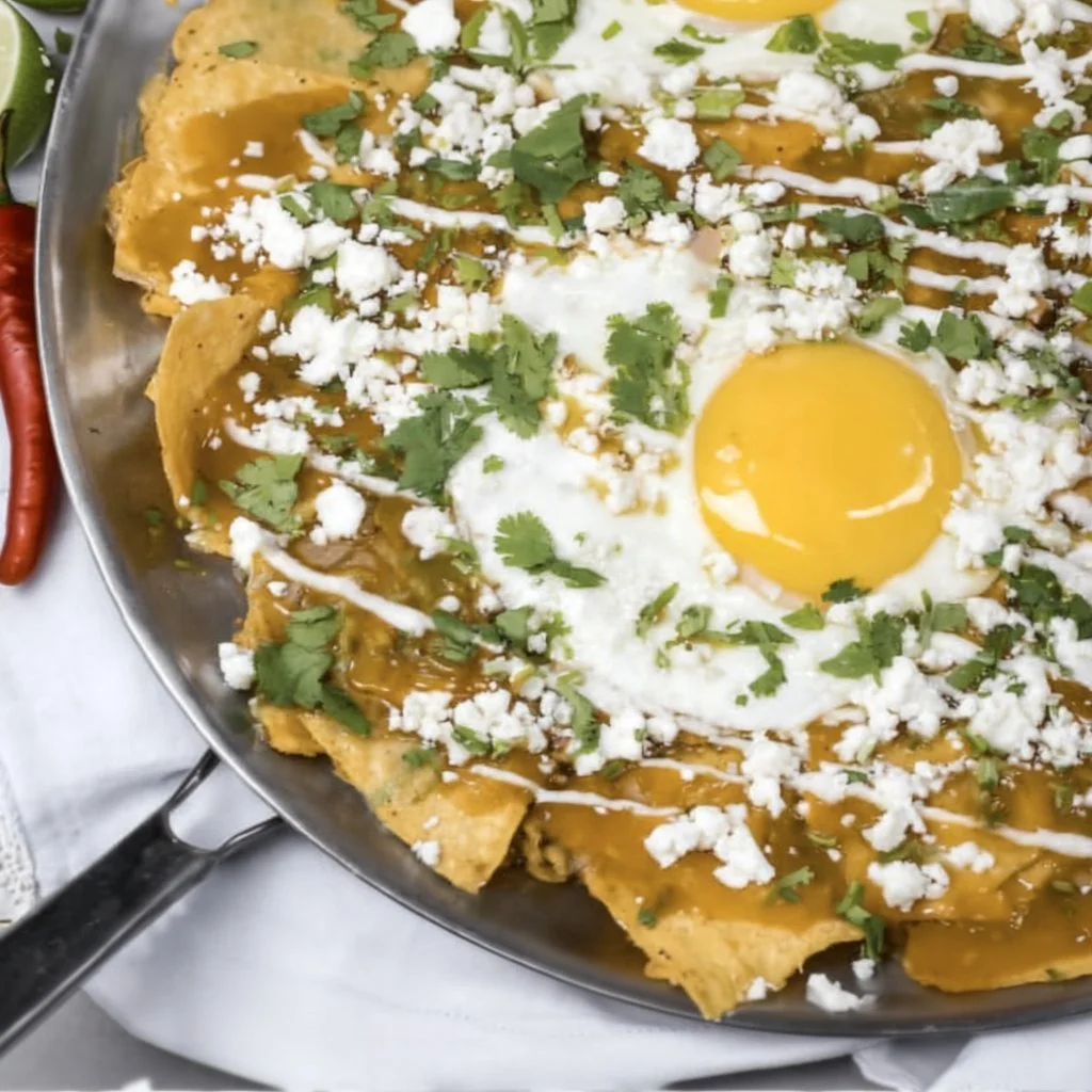 Chilaquiles topped with cheese and avocado, a comforting dish for busy days.