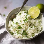 Bowl of coconut coriander lime rice with fresh cilantro and lime zest