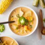 Bowl of Crockpot Queso Chicken Chowder garnished with cilantro