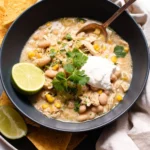 Delicious Crockpot white chicken chili garnished with herbs