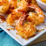 Deliciously crispy coconut shrimp served with a side of dipping sauce