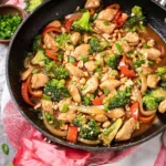 Delicious Easy Peanut Chicken Stir Fry with vegetables served in a bowl