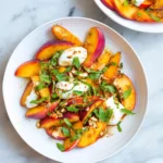 Fresh Peach Burrata Salad with creamy burrata and sliced peaches on a plate