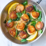 Delicious Garlic Basil Seared Scallops served on a plate with herbs