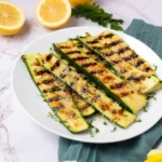 Grilled Parmesan Zucchini on a plate, garnished and ready to serve