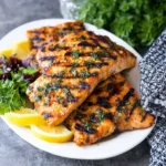 Delicious grilled salmon served with vegetables on a plate for dinner.