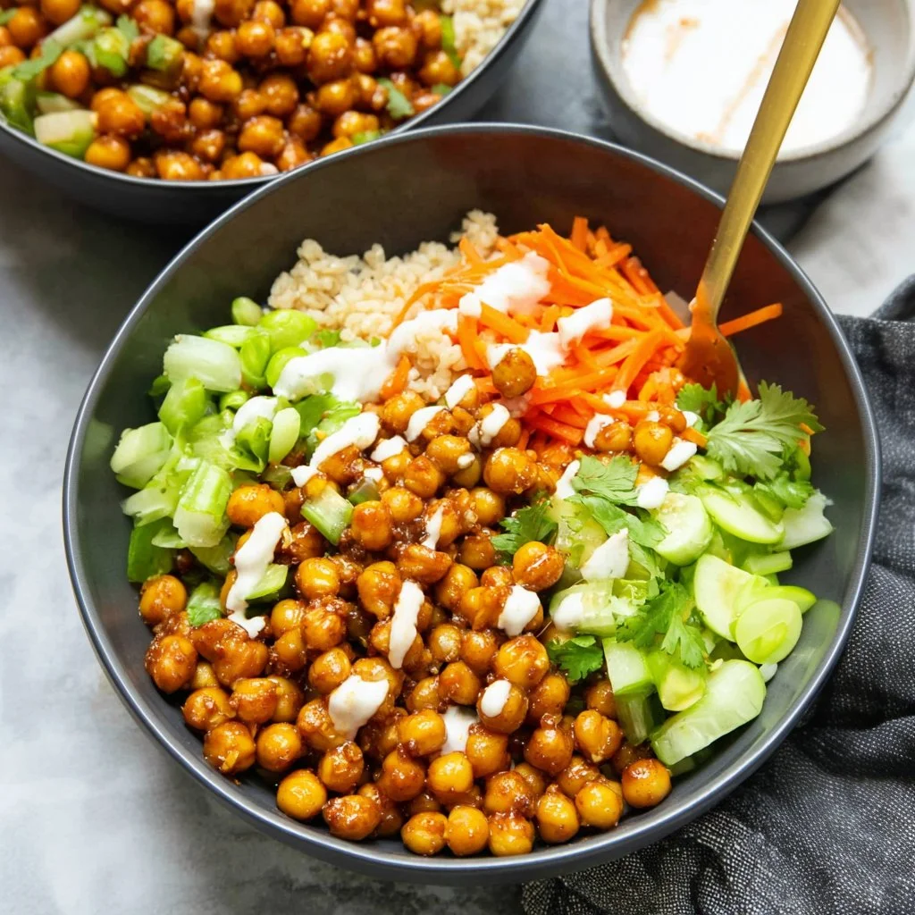 Delicious hot honey chickpea bowls topped with fresh vegetables and herbs