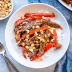 Delicious Kung Pao Beef served in a bowl with vegetables and peanuts