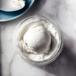 Homemade Ninja Creami coconut ice cream in a bowl with toppings.