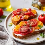 Deliciously prepared tomato toast topped with fresh herbs and spices.