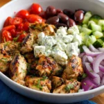 Delicious skillet Greek chicken with colorful veggies and herbs served on a plate