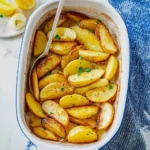 Delicious Greek lemon potatoes garnished with herbs and spices