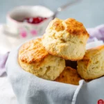 Freshly baked classic scones on a rustic table, perfect for tea time.