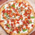 Homemade bruschetta pizza topped with fresh tomatoes and basil