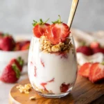 5-minute strawberry cheesecake breakfast parfait with fresh strawberries and cream