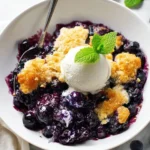Freshly baked blueberry cobbler with a golden crust and juicy blueberries