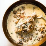 Delicious dish of Champagne Chicken garnished with fresh herbs and served elegantly.