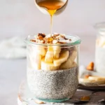 Delicious chia pudding with coconut milk topped with berries and nuts.