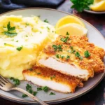 Crispy Chicken Schnitzel served with garnish and lemon