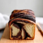 A beautifully braided chocolate babka loaf, showcasing its rich and decadent filling.