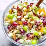 Classic Waldorf salad with apples, walnuts, and celery served on a plate.